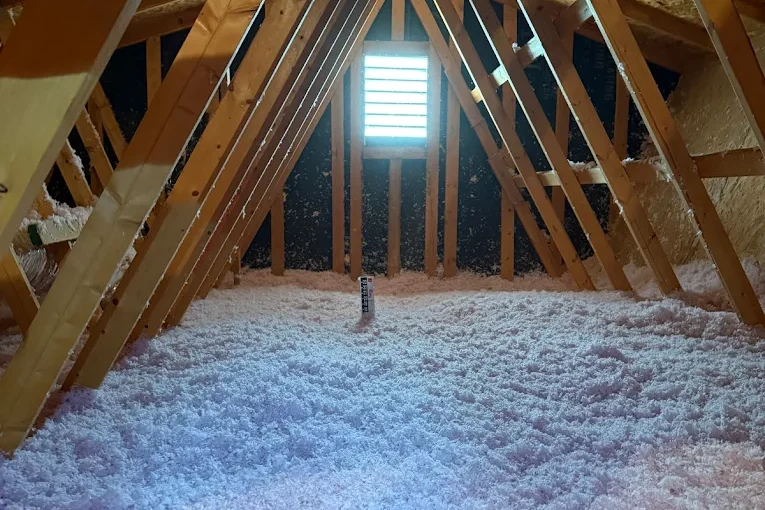 Blown in fiberglass installed evenly across the attic floor